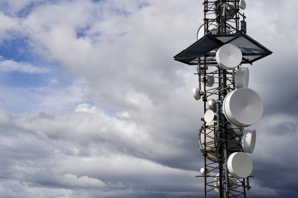 aerospace telecommunications towers against cloudy sky background